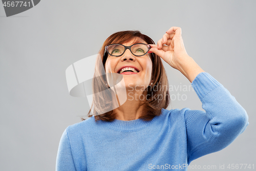 Image of portrait of senior woman in glasses looking up