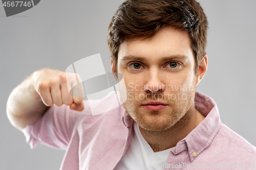 Image of angry young man ready for fist punch