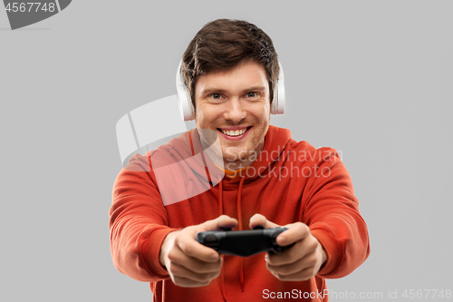 Image of man with gamepad playing video game