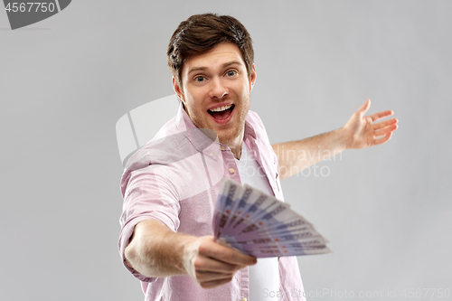 Image of happy young man with fan of euro money