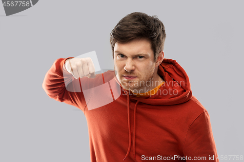 Image of angry young man ready for fist punch