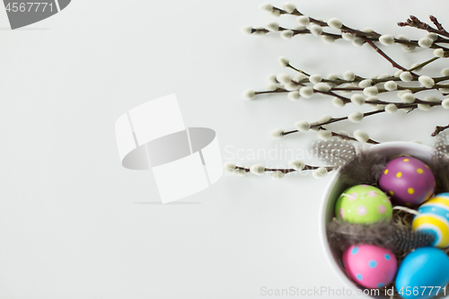 Image of colored easter eggs and pussy willow branches