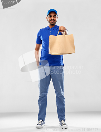 Image of happy indian delivery man with food in paper bag