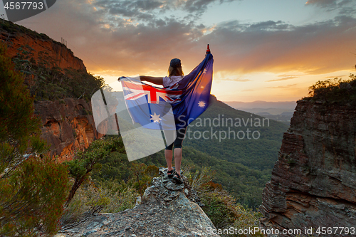 Image of Patriotic woman holding Australian flag in Blue Mountains Austra