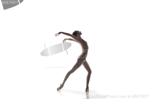 Image of Ballerina. Young graceful female ballet dancer dancing isolated on white. Beauty of classic ballet.