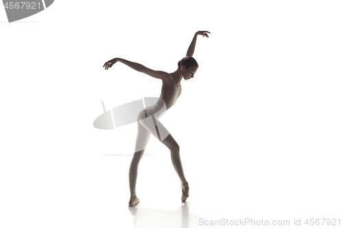 Image of Ballerina. Young graceful female ballet dancer dancing isolated on white. Beauty of classic ballet.