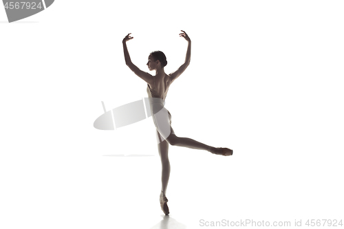 Image of Ballerina. Young graceful female ballet dancer dancing isolated on white. Beauty of classic ballet.