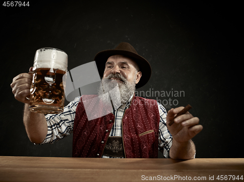 Image of Germany, Bavaria, Upper Bavaria, man with beer dressed in in traditional Austrian or Bavarian costume