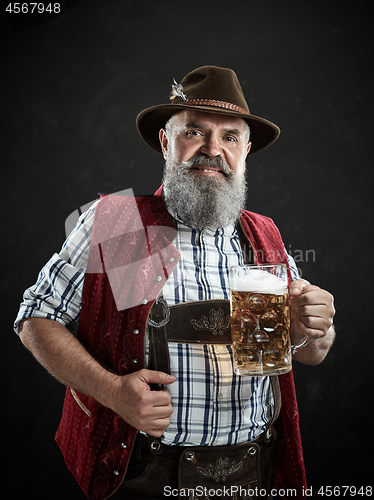 Image of Germany, Bavaria, Upper Bavaria, man with beer dressed in in traditional Austrian or Bavarian costume