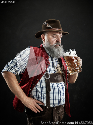 Image of Germany, Bavaria, Upper Bavaria, man with beer dressed in in traditional Austrian or Bavarian costume