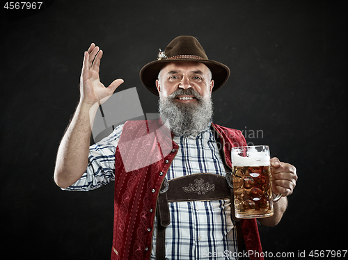 Image of Germany, Bavaria, Upper Bavaria, man with beer dressed in in traditional Austrian or Bavarian costume