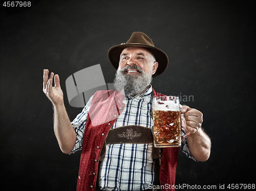 Image of Germany, Bavaria, Upper Bavaria, man with beer dressed in in traditional Austrian or Bavarian costume