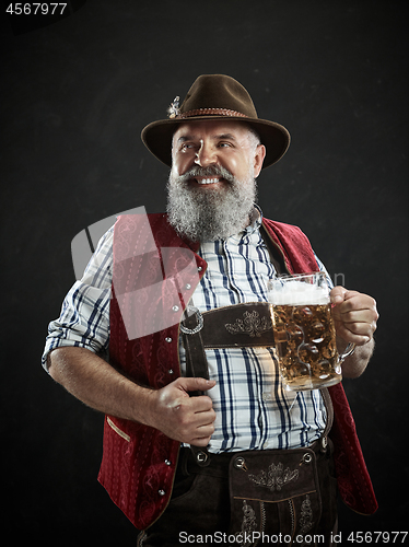 Image of Germany, Bavaria, Upper Bavaria, man with beer dressed in in traditional Austrian or Bavarian costume