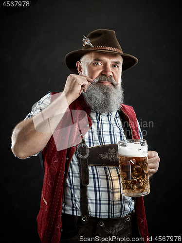 Image of Germany, Bavaria, Upper Bavaria, man with beer dressed in in traditional Austrian or Bavarian costume