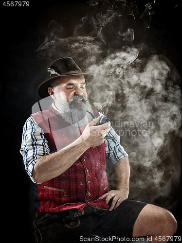 Image of dramatic portrait of senior smoking tobacco pipe