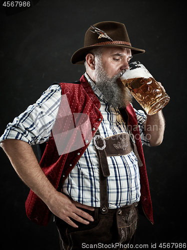 Image of Germany, Bavaria, Upper Bavaria, man with beer dressed in in traditional Austrian or Bavarian costume