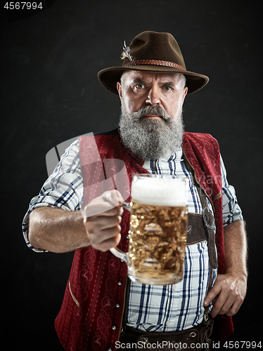 Image of Germany, Bavaria, Upper Bavaria, man with beer dressed in in traditional Austrian or Bavarian costume