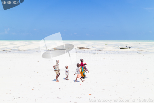 Image of Paje, Zanzibar - Feb 9, 2015: Local kids walking at Paje village picture perfect white beach at low tide on February 9th, 2015 on Zanzibar, Tanzania