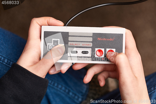 Image of Nintengo NES,playing Super Mario 3