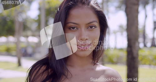 Image of Sensual Asian woman with naked shoulder looking at camera