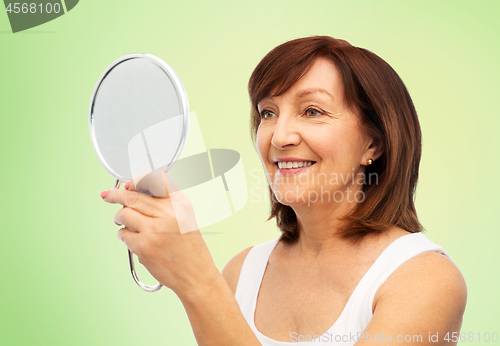 Image of portrait of smiling senior woman with mirror