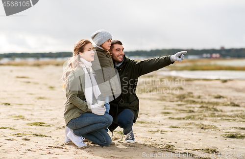 Image of happy family on autumn beach