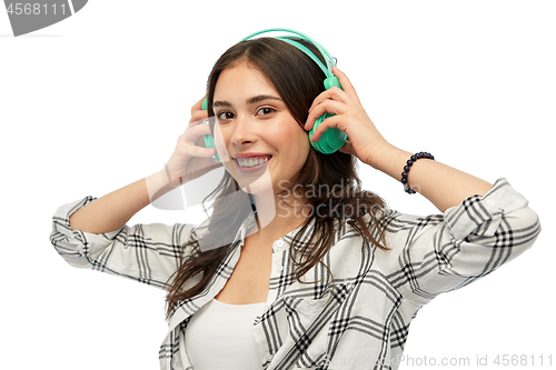 Image of happy young woman or teenage girl with headphones