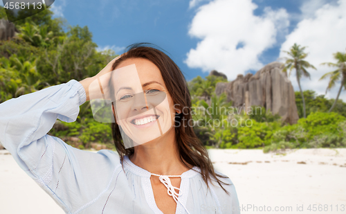 Image of happy smiling woman on summer beach