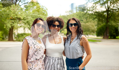 Image of happy young women in sunglasses at summer park