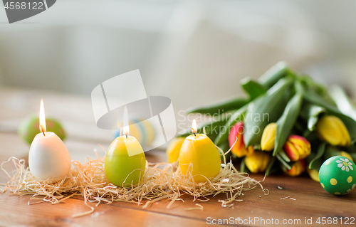 Image of candles in shape of easter eggs and tulip flowers