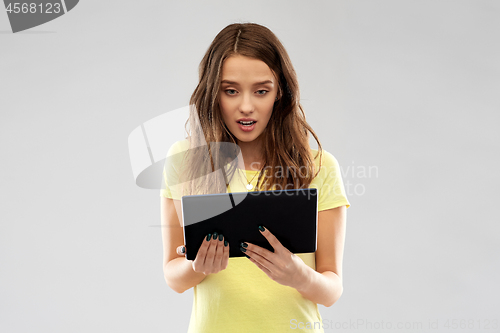 Image of young woman or teenage girl using tablet computer