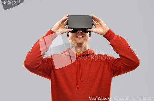 Image of happy man in virtual reality headset or vr glasses