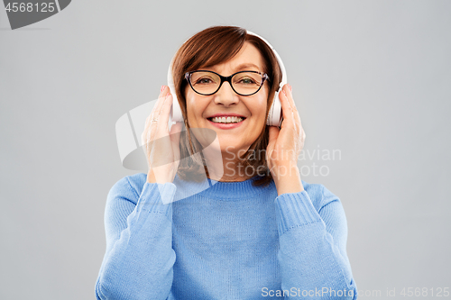 Image of senior woman in headphones listening to music