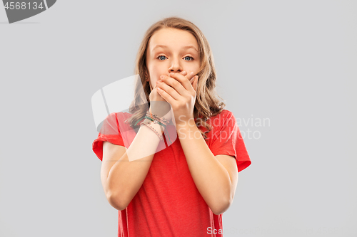 Image of shocked teenage girl covering her mouth by hands