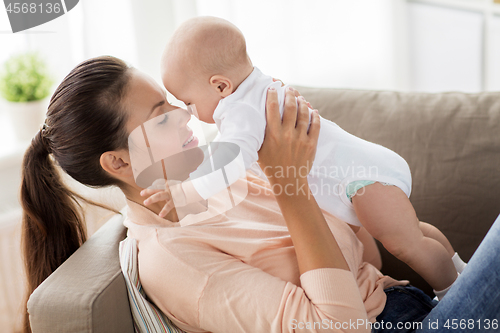 Image of happy mother with little baby boy at home