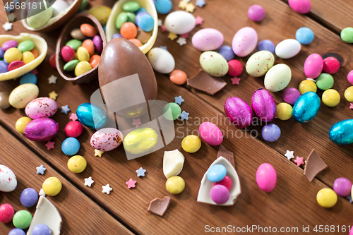 Image of chocolate eggs and candy drops on wooden table