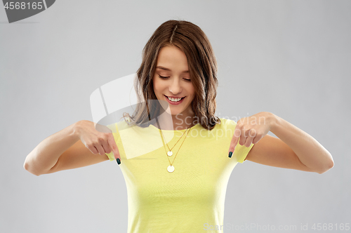 Image of young woman or teenage girl in yellow t-shirt