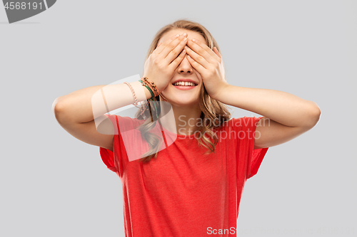 Image of smiling teenage girl in red t-shirt over grey