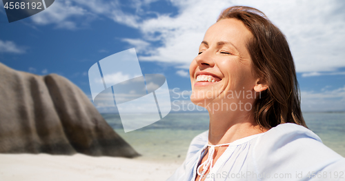 Image of happy woman over seychelles island tropical beach