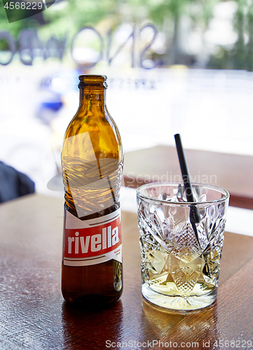 Image of Bottle and glass of swiss popular lemonade Rivella