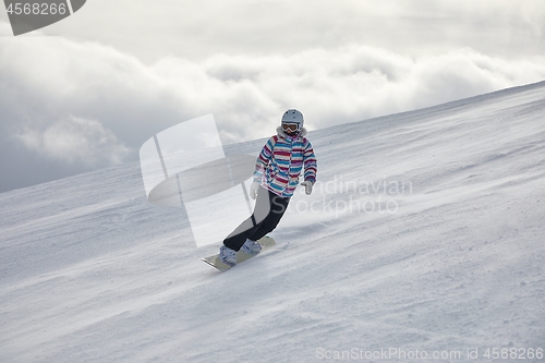 Image of Female snowboarder on the slope