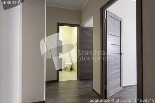 Image of Corridor in a small apartment, open doors to the bathroom and room