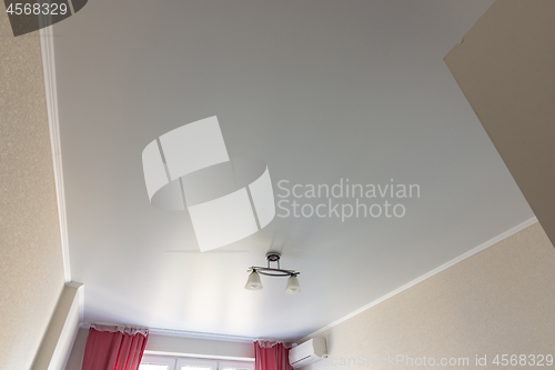 Image of Stretched white matte ceiling in the room close-up