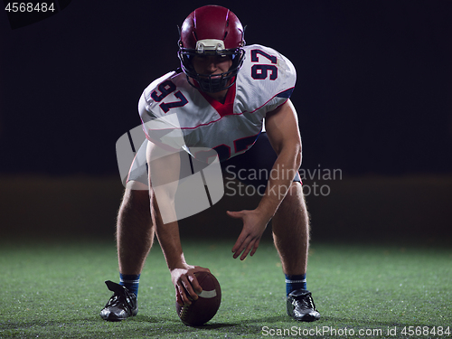 Image of American football player starting football game