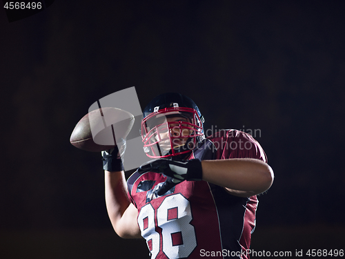 Image of american football player throwing rugby ball