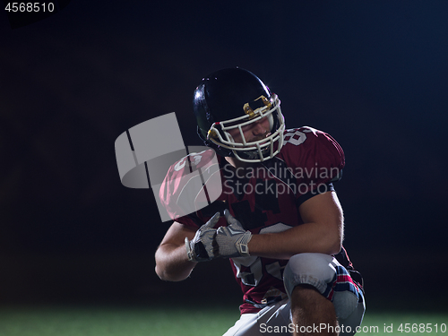 Image of portrait of young confident American football player