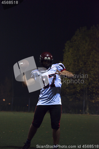 Image of american football player throwing rugby ball