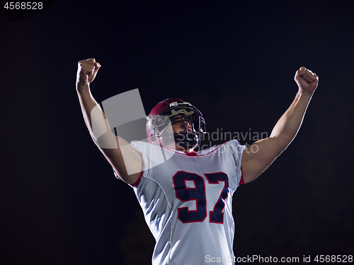 Image of american football player celebrating after scoring a touchdown