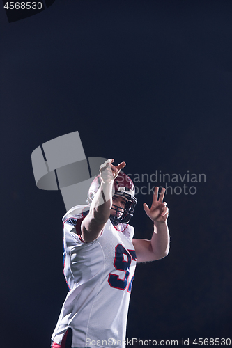 Image of american football player throwing rugby ball