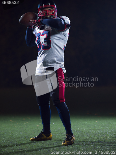 Image of american football player throwing rugby ball